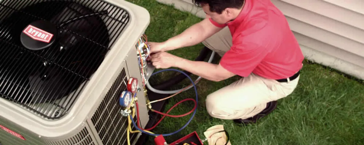 HVAC technician servicing an outdoor air conditioner unit in Minneapolis, MN